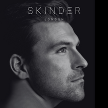Загрузить изображение в средство просмотра галереи, a black and white image of a man with clear, hydrated, smooth, even skin. the SKINDER LONDON logo is at the top of the screen. this image shows hybrid multi use skincare and beauty for men. @skinderofficial

